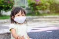 Happy Asian child girl smiling and wearing fabric mask. She playingÃ¢â¬â¹ at the playground. socialÃ¢â¬â¹ Distance. Learning and active Royalty Free Stock Photo